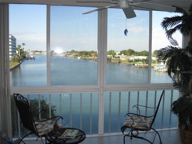 sunroom / solarium with a wealth of natural light and a water view