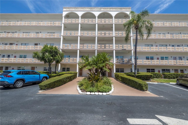 view of property featuring uncovered parking