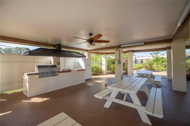 view of patio / terrace featuring area for grilling, fence, and a ceiling fan