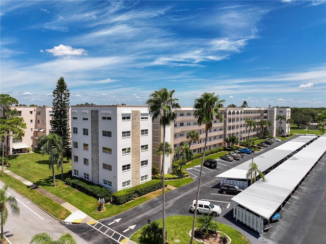 view of building exterior with uncovered parking