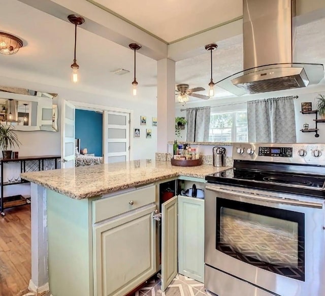 kitchen with pendant lighting, ventilation hood, ceiling fan, electric range, and light wood-type flooring