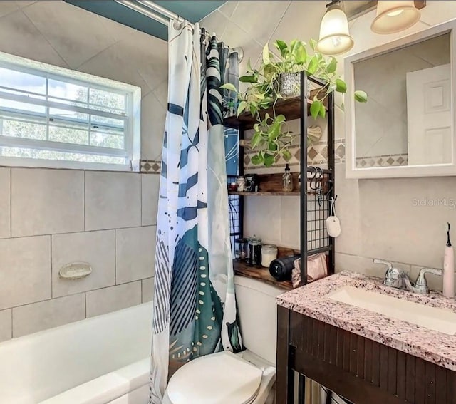 full bathroom with shower / bath combination with curtain, toilet, and vanity