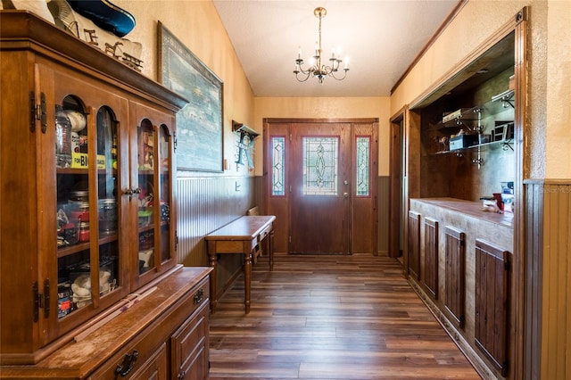 interior space featuring a notable chandelier and dark hardwood / wood-style flooring