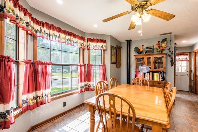 dining space featuring light tile flooring and ceiling fan