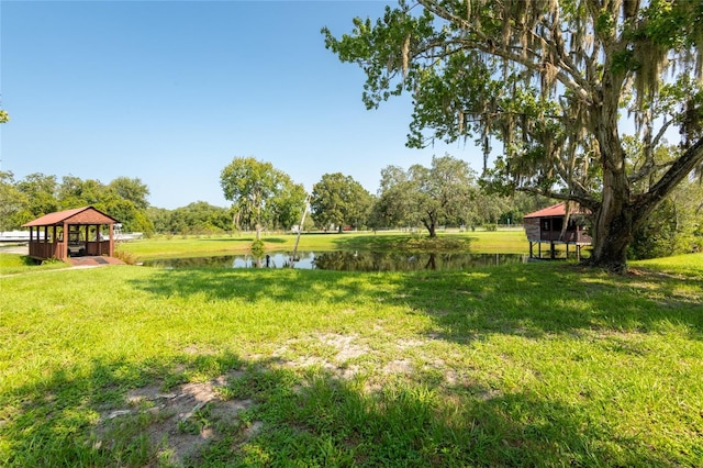 view of yard featuring a gazebo and a water view