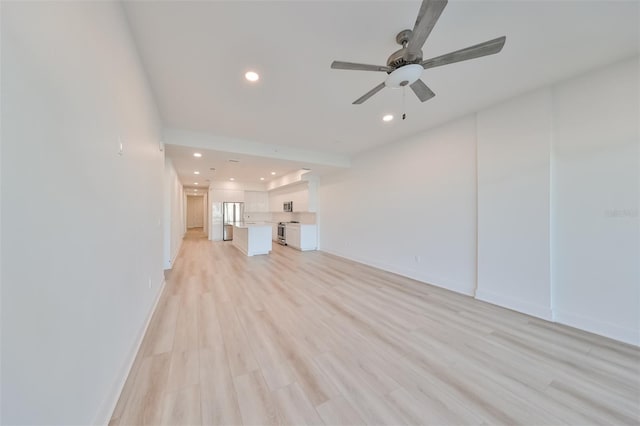 unfurnished living room with a ceiling fan, recessed lighting, light wood-style flooring, and baseboards