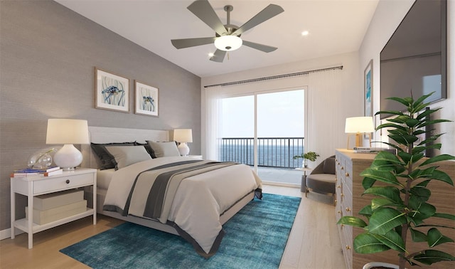 bedroom featuring access to exterior, an accent wall, wallpapered walls, and wood finished floors