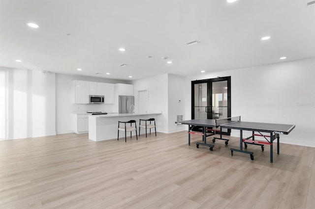 rec room with visible vents, recessed lighting, light wood-style floors, and french doors