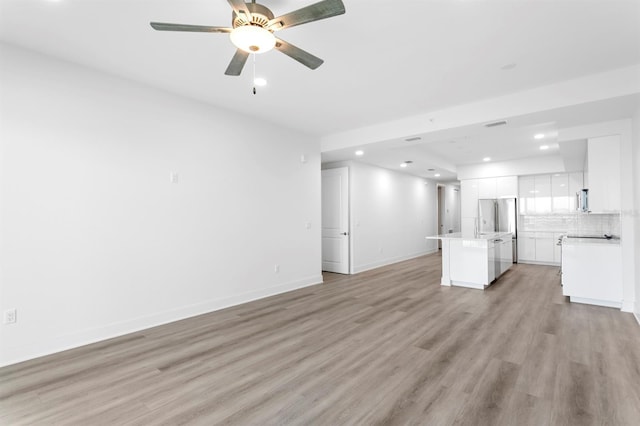 unfurnished living room with baseboards, light wood-style flooring, recessed lighting, and a ceiling fan
