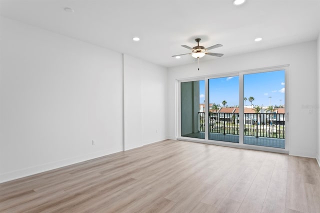 empty room with baseboards, light wood-style flooring, ceiling fan, and recessed lighting