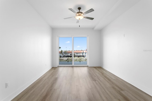 empty room with baseboards, light wood-style flooring, and a ceiling fan