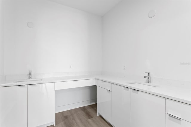 bathroom with a sink and wood finished floors