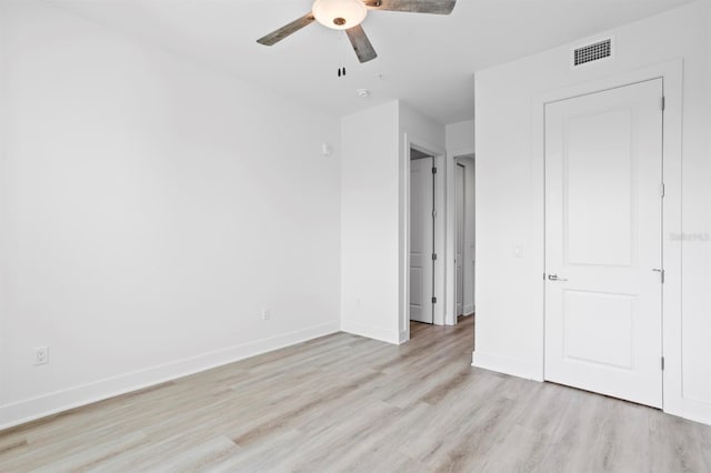 unfurnished bedroom with ceiling fan, baseboards, light wood finished floors, and visible vents
