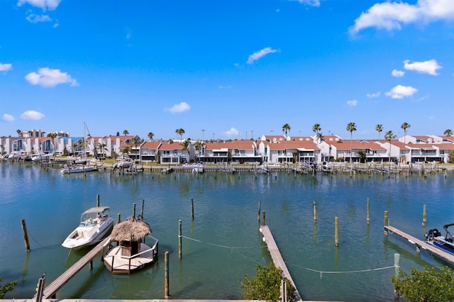 view of dock with a residential view and a water view