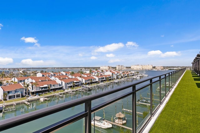 balcony featuring a residential view and a water view