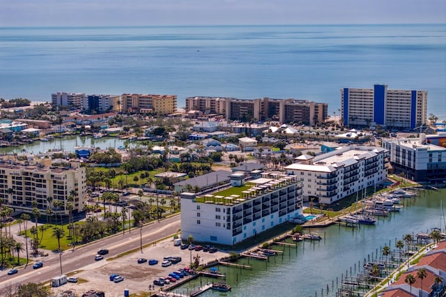 birds eye view of property with a water view and a view of city
