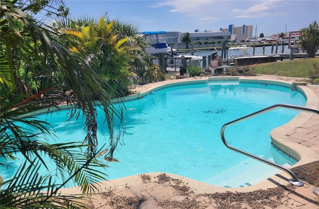 view of swimming pool featuring a water view