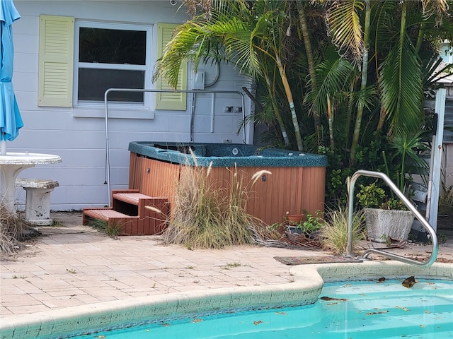 view of pool with cooling unit and a hot tub