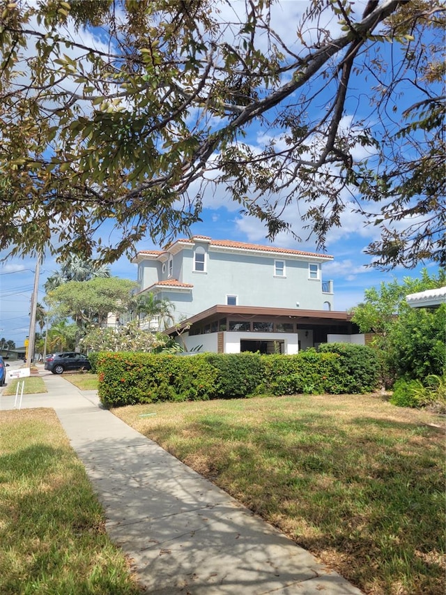 view of side of home with a yard