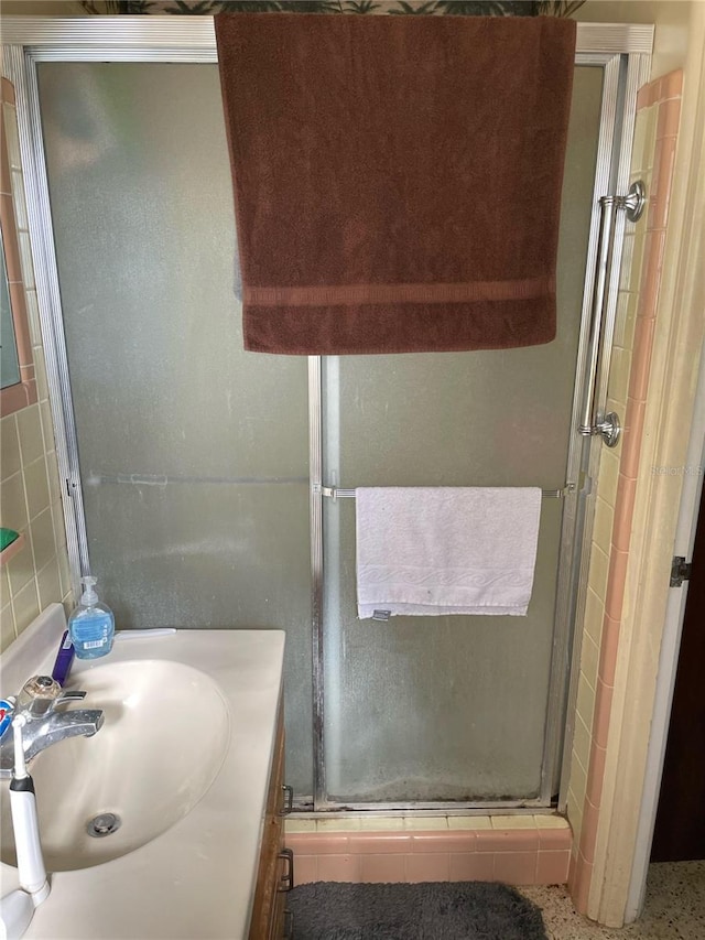 bathroom featuring vanity and an enclosed shower