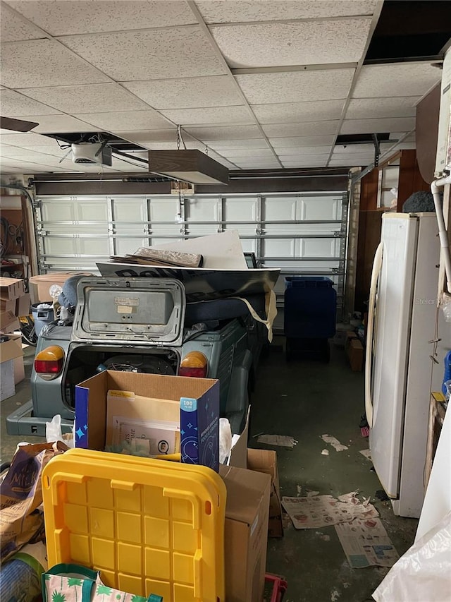 garage with white fridge and a garage door opener