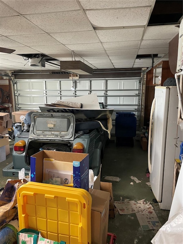 garage with white fridge and a garage door opener