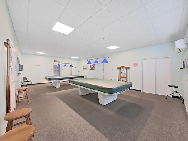 game room featuring a paneled ceiling, pool table, a wall mounted air conditioner, and carpet floors