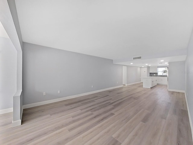 unfurnished living room featuring light wood-type flooring