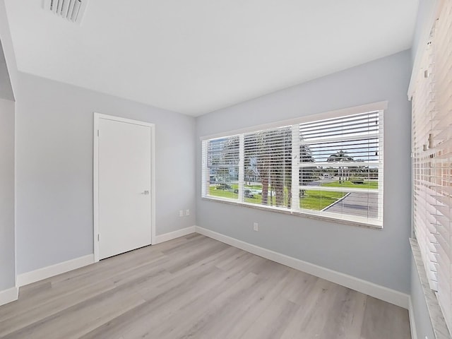 spare room with light wood-type flooring