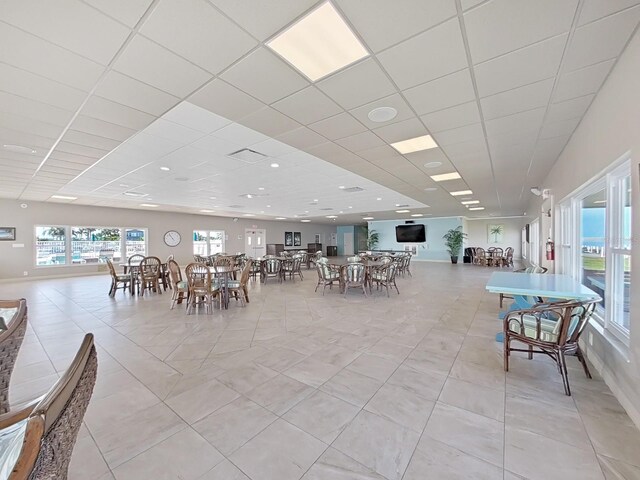 tiled dining area featuring a paneled ceiling