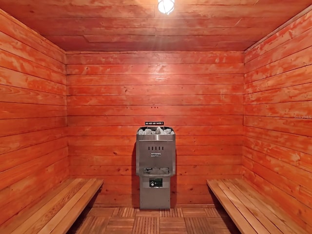 view of sauna with wood walls and wooden ceiling