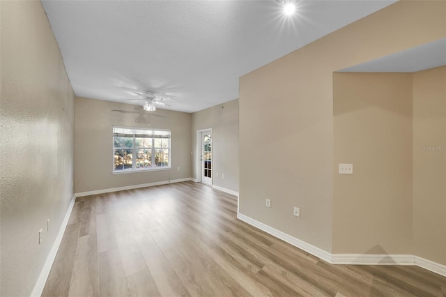 unfurnished living room with ceiling fan and light hardwood / wood-style flooring