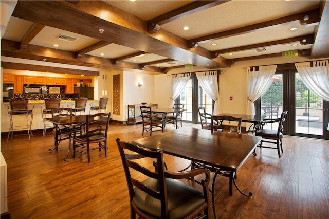 dining area featuring beam ceiling, light wood-type flooring, a wealth of natural light, and french doors