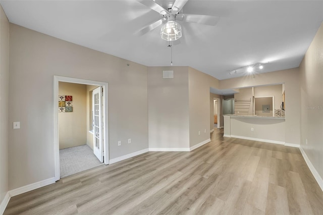 spare room featuring ceiling fan, rail lighting, and light hardwood / wood-style floors