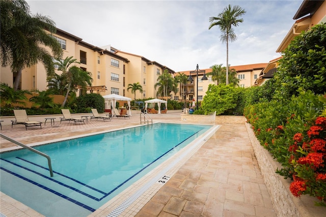 view of swimming pool with a gazebo and a patio