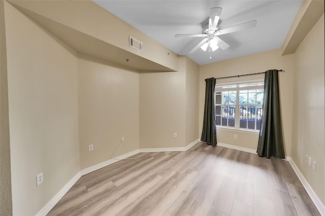 spare room with light wood-type flooring and ceiling fan