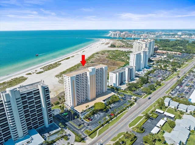 drone / aerial view with a water view and a view of the beach