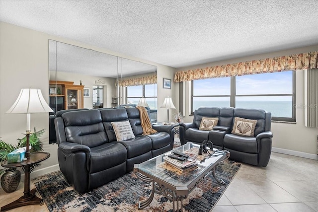 living room featuring light tile flooring and a textured ceiling