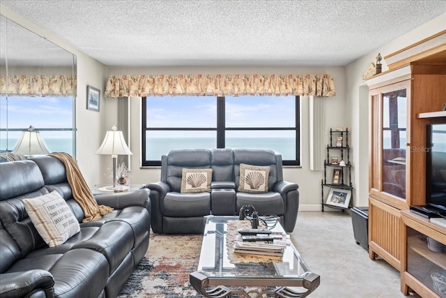 living room with plenty of natural light, light tile floors, and a textured ceiling