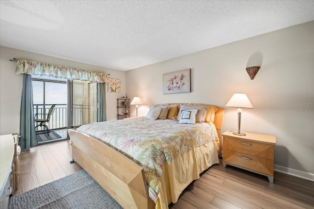 bedroom with a textured ceiling, access to exterior, and light wood-type flooring