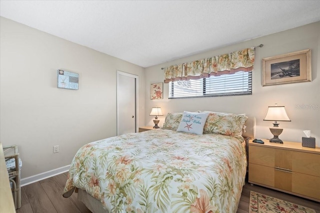 bedroom with dark wood-type flooring