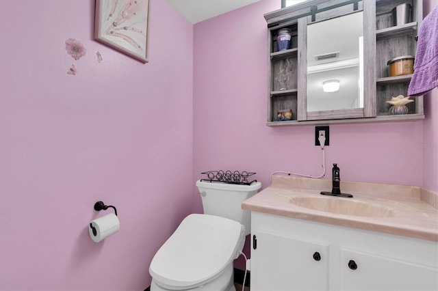 bathroom featuring toilet and vanity