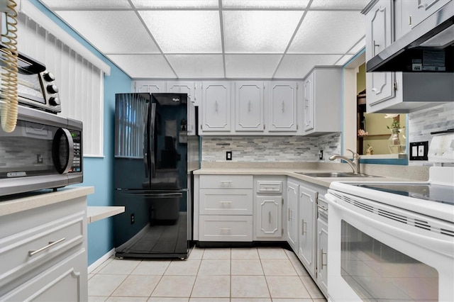 kitchen featuring black refrigerator, tasteful backsplash, white electric stove, and a paneled ceiling