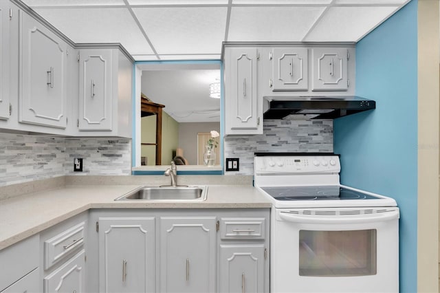 kitchen with a paneled ceiling, white electric range oven, tasteful backsplash, and sink