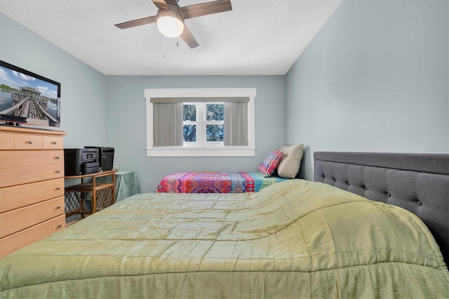 bedroom with a textured ceiling and ceiling fan