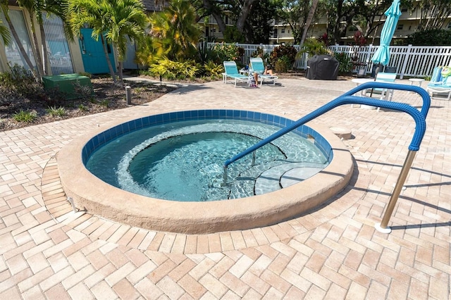 view of pool featuring a community hot tub and a patio