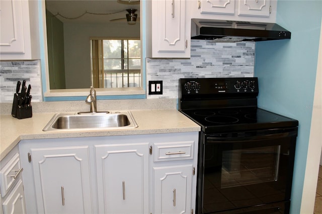 kitchen with sink, black / electric stove, custom range hood, decorative backsplash, and white cabinets