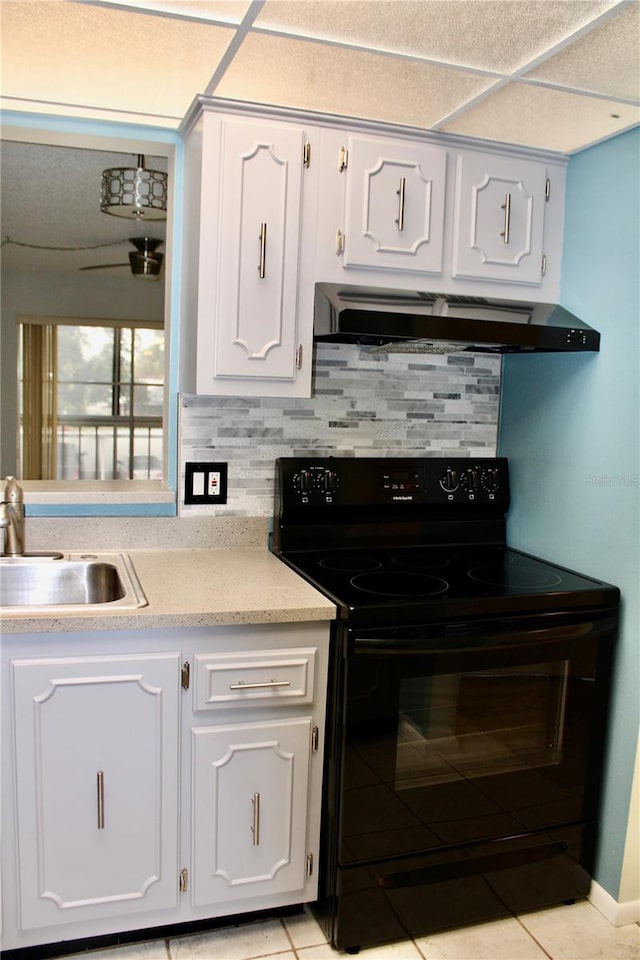 kitchen featuring sink, tasteful backsplash, ventilation hood, black / electric stove, and white cabinets