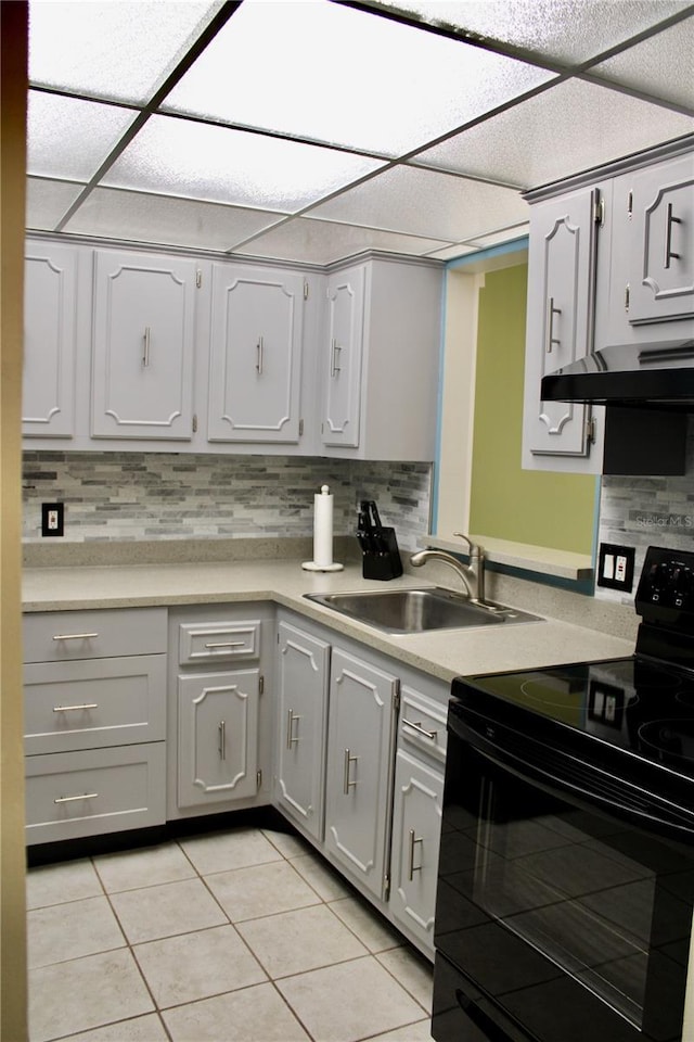 kitchen with black / electric stove, sink, tasteful backsplash, and light tile patterned floors