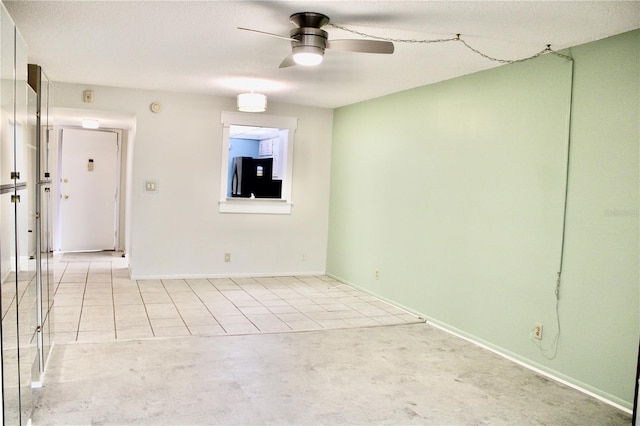 unfurnished room featuring ceiling fan and light tile patterned flooring